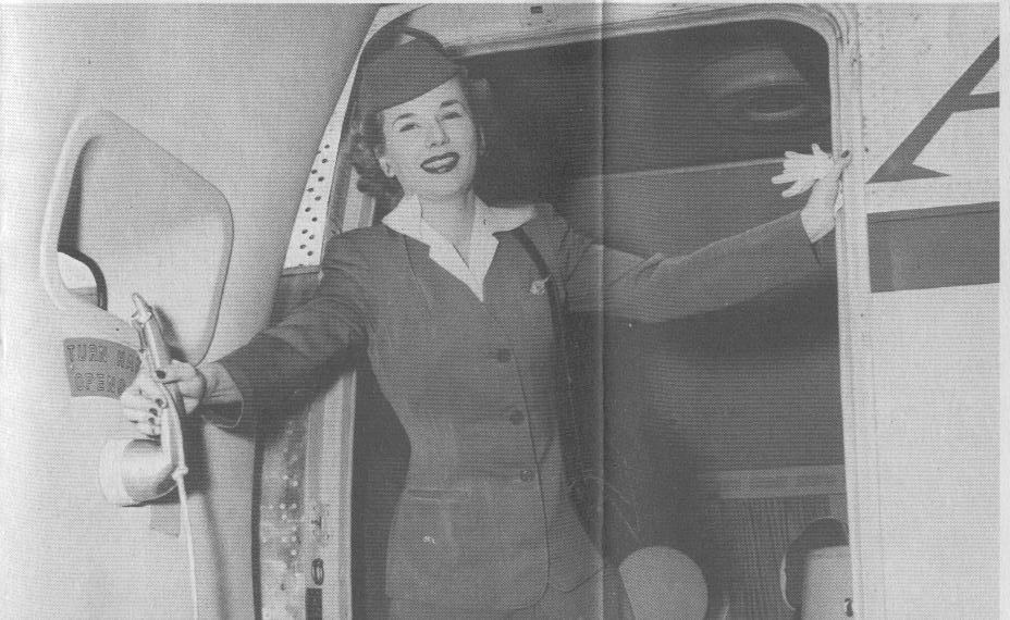 1950s A stewardess closing the door of a Boeing 377 Stratocruiser.